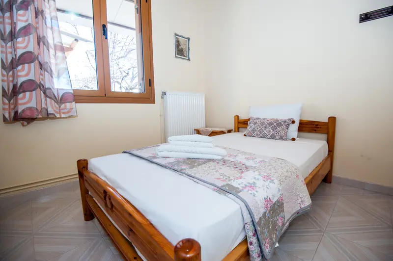 The smaller double bed beside the window