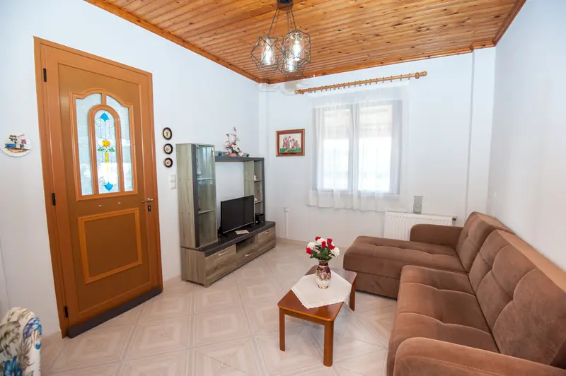 The living room under its timber-panelled ceiling